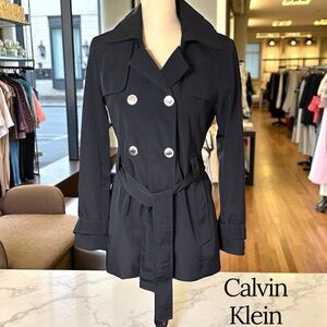 Calvin Klein-Classy black trench coat. Size small. Silver details/Hood. Like new